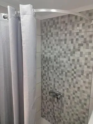 a bathroom with a shower with a shower curtain at lovely penthouse at the center! in Athens