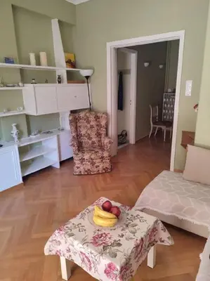 a living room with a table with a bowl of fruit on it at lovely penthouse at the center! in Athens
