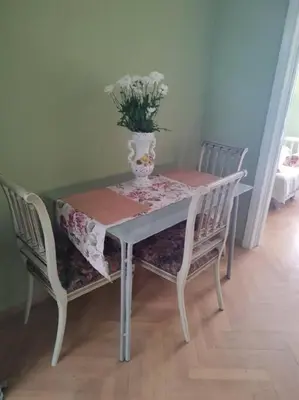 a table and chairs with a vase on top of it at lovely penthouse at the center! in Athens