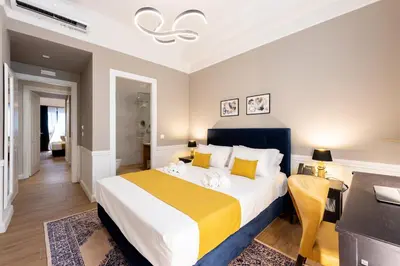 a bedroom with a large bed with a yellow blanket at Pure Hotel by Athens Prime Hotels in Athens