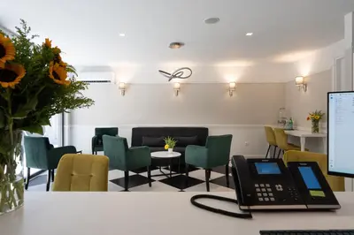 a room with chairs and a desk with a laptop at Pure Hotel by Athens Prime Hotels in Athens
