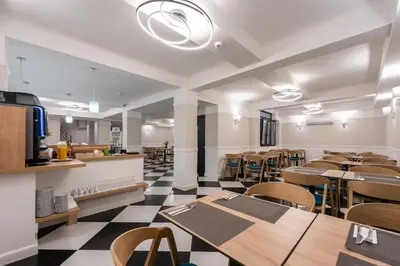 a restaurant with tables and chairs and a counter at Pure Hotel by Athens Prime Hotels in Athens