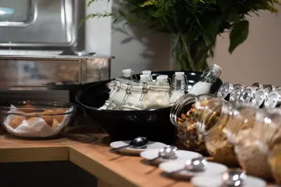 a kitchen counter with a table with glass jars on it at Pure Hotel by Athens Prime Hotels in Athens