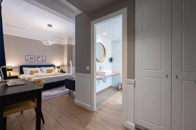a bedroom with a bed and a desk and a room at Pure Hotel by Athens Prime Hotels in Athens