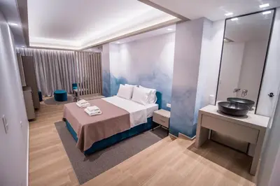 a hotel room with a bed and a mirror at Millennial Apartments Trikoupi in Athens