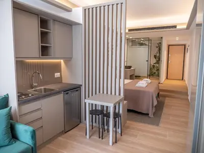 a kitchen and a living room with a bed at Millennial Apartments Trikoupi in Athens