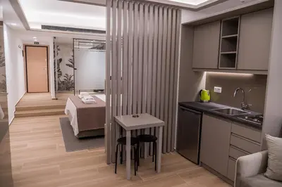 a kitchen with a sink and a bed in a room at Millennial Apartments Trikoupi in Athens