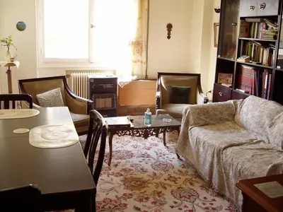 a living room with a couch and a table at PRIVATE BEDROOMS IN SHARED APARTMENT 135 SM ATHENS Center in Athens
