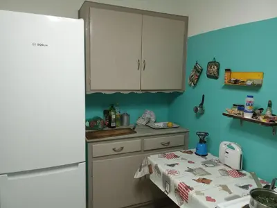 a kitchen with a white refrigerator and a table at PRIVATE BEDROOMS IN SHARED APARTMENT 135 SM ATHENS Center in Athens