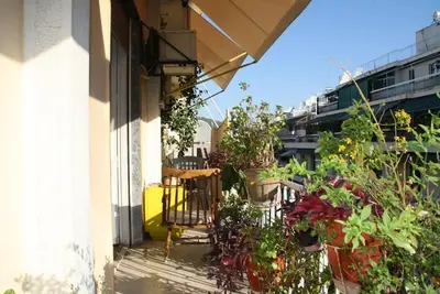 a balcony with potted plants on the side of a building at PRIVATE BEDROOMS IN SHARED APARTMENT 135 SM ATHENS Center in Athens