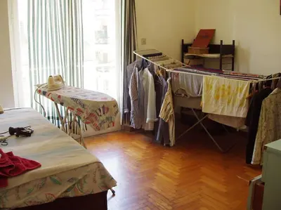 a room with a bunch of clothes hanging up at PRIVATE BEDROOMS IN SHARED APARTMENT 135 SM ATHENS Center in Athens