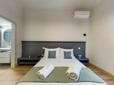 a bedroom with a large bed with two pillows at KASO - Fotomara in Athens