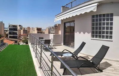 a balcony with chairs and a table on a building at Dreamy Athens Loft with City View in Athens