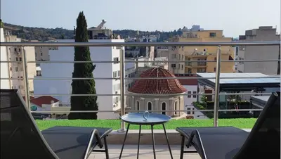 a table on a balcony with a view of a city at Dreamy Athens Loft with City View in Athens