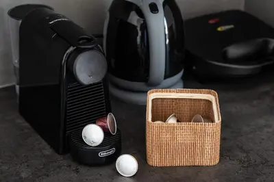 a coffee maker with eggs in a basket next to a toaster at Dreamy Athens Loft with City View in Athens