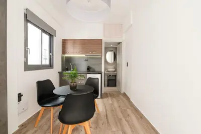 a kitchen with a table and chairs in a room at Dreamy Athens Loft with City View in Athens