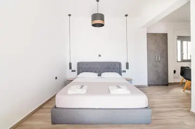 a bedroom with a large bed with white sheets at Dreamy Athens Loft with City View in Athens