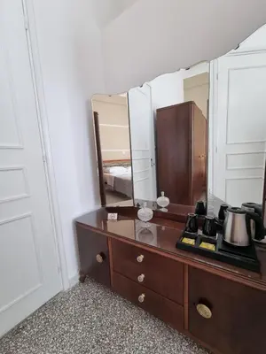 a room with a dresser with a mirror at Hall Apartments & Rooms - by Avelink in Spáta