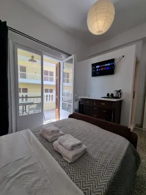 a bedroom with a bed with two towels on it at Hall Apartments & Rooms - by Avelink in Spáta