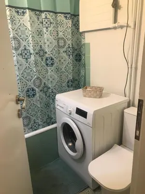 a washing machine in a bathroom with a toilet at Athens Apartment 1-min Walk to Kato Patissia Metro in Athens