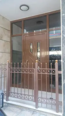 a front door of a building with a gate at Athens Apartment 1-min Walk to Kato Patissia Metro in Athens