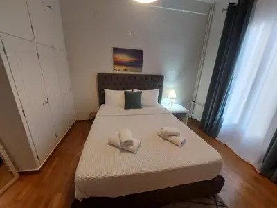 a bedroom with a bed with two towels on it at Athens Apartment 1-min Walk to Kato Patissia Metro in Athens