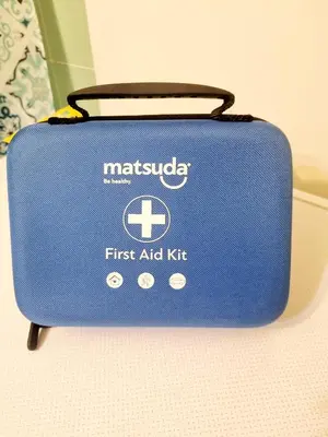 a blue suitcase with the first aid kit on it at Athens Apartment 1-min Walk to Kato Patissia Metro in Athens