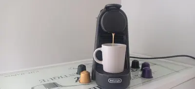 a coffee maker with a cup on top of a laptop at Athens Apartment 1-min Walk to Kato Patissia Metro in Athens