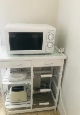 a microwave oven sitting on top of a table at Athens Apartment 1-min Walk to Kato Patissia Metro in Athens