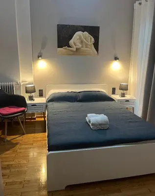 a bedroom with a bed with a towel on it at Cozy flat in Hilton, central Athens, 3' metro, VFM! in Athens