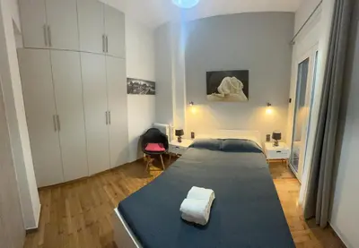 a bedroom with a large bed in a room at Cozy flat in Hilton, central Athens, 3' metro, VFM! in Athens