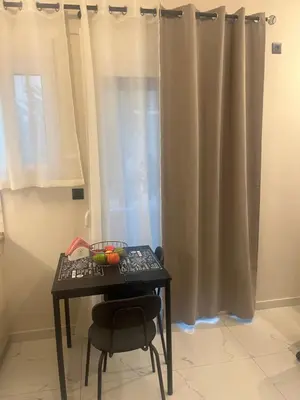 a table with a keyboard and a chair next to a window at Cozy flat in Hilton, central Athens, 3' metro, VFM! in Athens