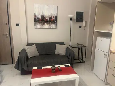a living room with a couch and a table at Cozy flat in Hilton, central Athens, 3' metro, VFM! in Athens