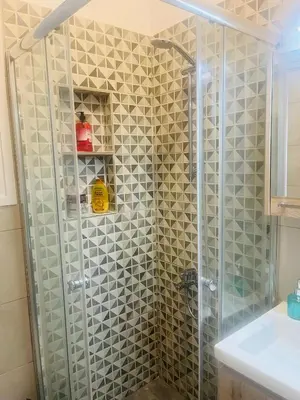 a shower in a bathroom with a glass shower stall at Cozy flat in Hilton, central Athens, 3' metro, VFM! in Athens