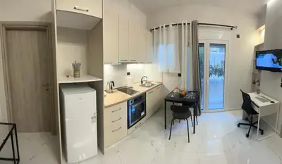 a kitchen with a sink and a table in it at Cozy flat in Hilton, central Athens, 3' metro, VFM! in Athens