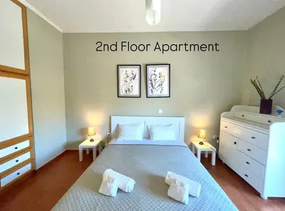 a bedroom with a bed and floor appointment on the wall at Aggelou Apartments-10 min from Athens airport in Spáta