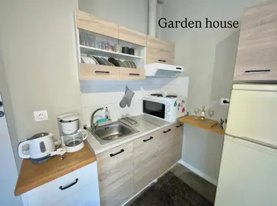 a small kitchen with a sink and a white refrigerator at Aggelou Apartments-10 min from Athens airport in Spáta