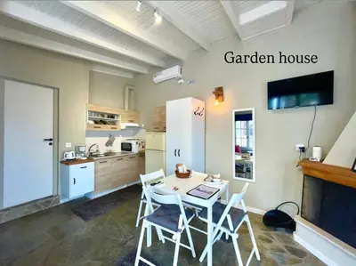 a kitchen with a table and chairs in a room at Aggelou Apartments-10 min from Athens airport in Spáta