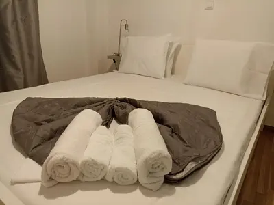 a group of rolled towels on a bed at Pagrati apartment Διαμέρισμα Παγκράτι in Athens