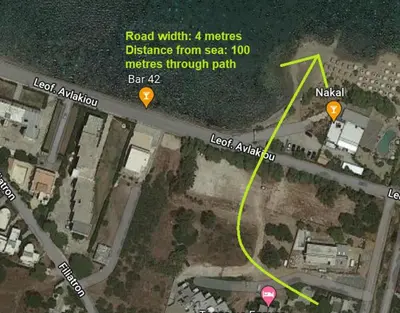 a map of a road with a yellow line and some signs at Architect's summer house by the beach in Porto Rafti