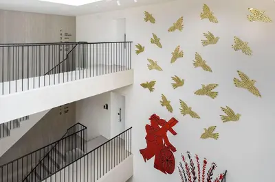 a staircase in a building with butterflies on the wall at The Newel Psychiko in Athens