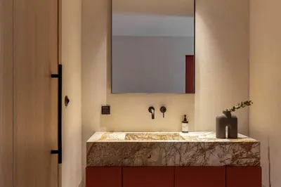 a bathroom with a marble sink and a mirror at The Newel Psychiko in Athens