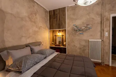 a bedroom with a large bed in a room at MS APARTMENT in Athens