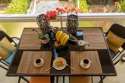 a table with a basket of bananas and a bowl of fruit at MS APARTMENT in Athens