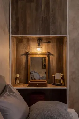a bedroom with a mirror on a wooden wall at MS APARTMENT in Athens