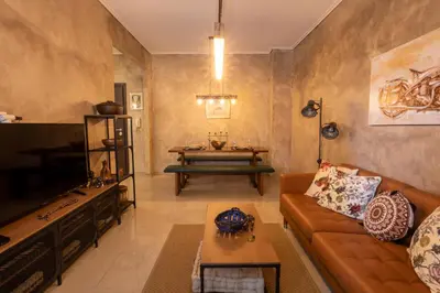 a living room with a couch and a table at MS APARTMENT in Athens