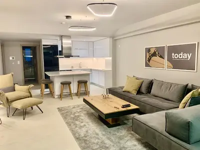 a living room with a couch and a table at Fab New Flat in Central Athens w/ Acropolis Views in Athens