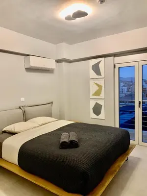 a bedroom with a bed with shoes on it at Fab New Flat in Central Athens w/ Acropolis Views in Athens