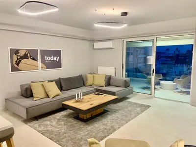 a living room with a couch and a coffee table at Fab New Flat in Central Athens w/ Acropolis Views in Athens