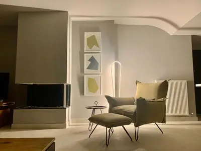 a living room with a chair and a television at Fab New Flat in Central Athens w/ Acropolis Views in Athens